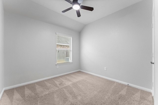 carpeted empty room featuring lofted ceiling and ceiling fan