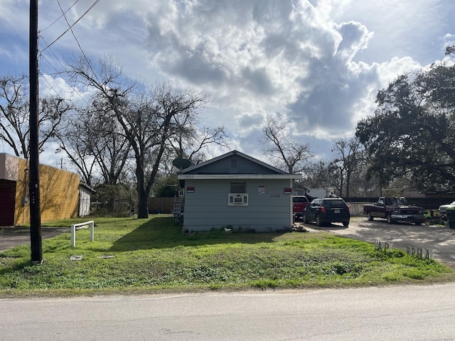 view of side of home with a lawn