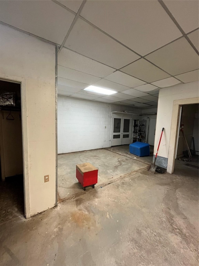 basement featuring a paneled ceiling