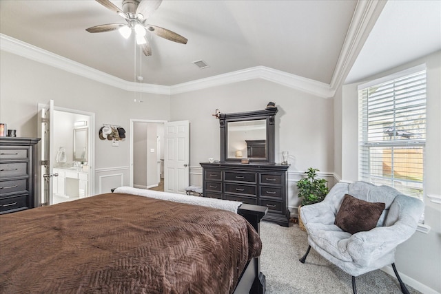 bedroom with vaulted ceiling, connected bathroom, light colored carpet, ceiling fan, and crown molding