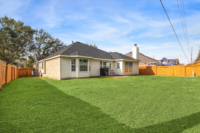 rear view of house with a lawn, central air condition unit, and a patio area