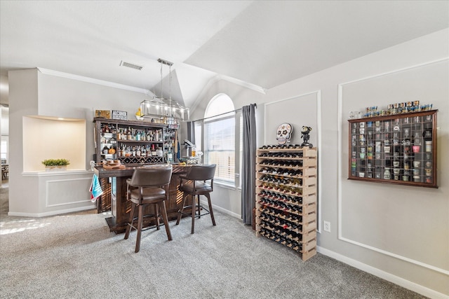 wine cellar featuring lofted ceiling, carpet floors, and bar area