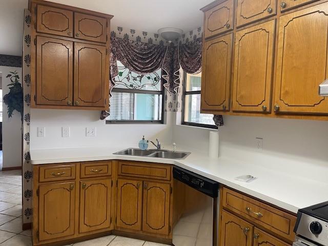 kitchen featuring sink, light tile patterned floors, and stainless steel dishwasher