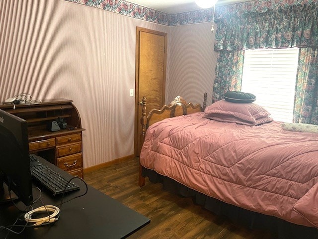 bedroom with dark hardwood / wood-style flooring