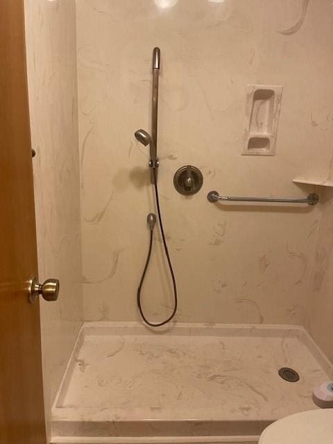 bathroom with tiled shower