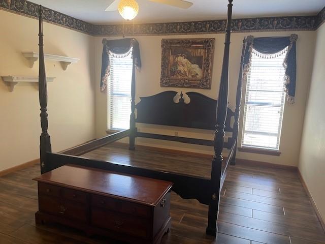 bedroom with dark hardwood / wood-style floors and ceiling fan