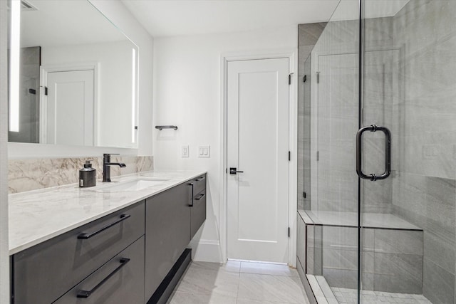 bathroom with walk in shower and vanity