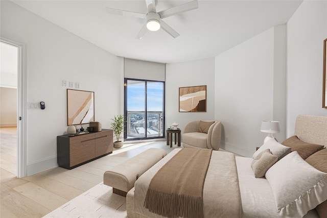 bedroom with ceiling fan and light hardwood / wood-style flooring