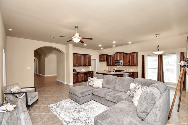 tiled living room with ceiling fan