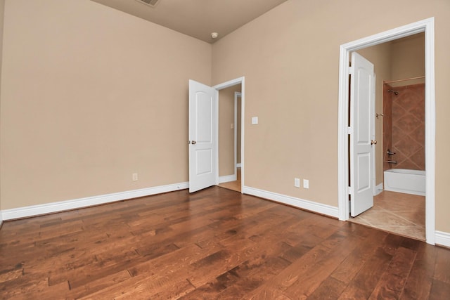 unfurnished bedroom featuring dark hardwood / wood-style floors