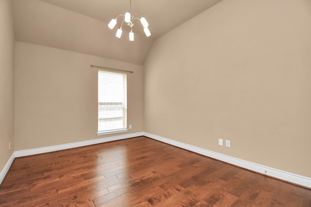 unfurnished room featuring an inviting chandelier, dark hardwood / wood-style flooring, and vaulted ceiling