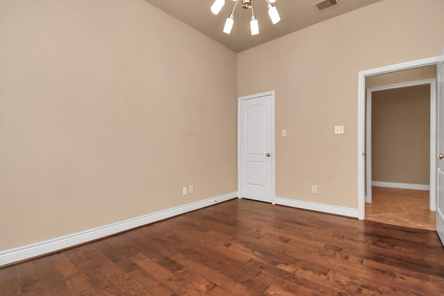 empty room with dark hardwood / wood-style flooring