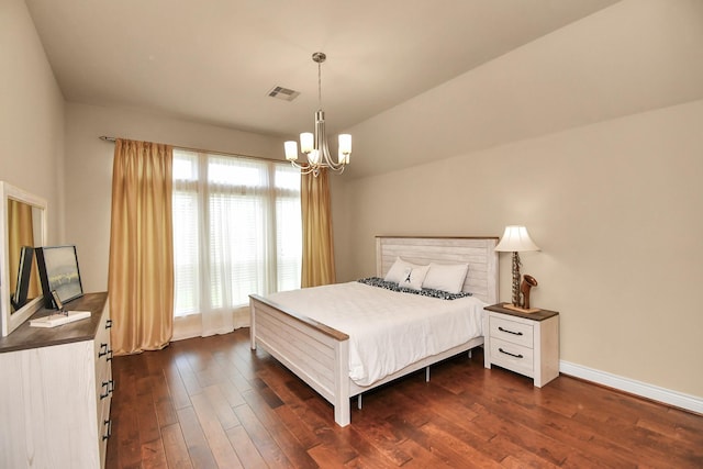 bedroom with dark hardwood / wood-style flooring and a chandelier