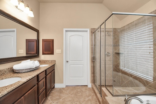 bathroom featuring vanity, tile patterned floors, lofted ceiling, and walk in shower