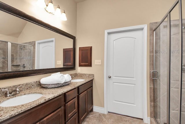 bathroom featuring tile patterned flooring, vanity, a shower with door, and lofted ceiling