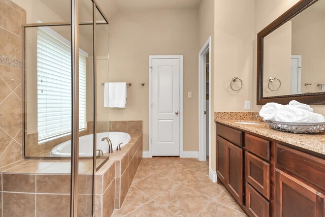 bathroom with tile patterned floors, vanity, and separate shower and tub