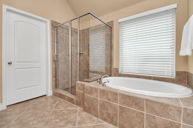 bathroom with lofted ceiling, separate shower and tub, and tile patterned flooring