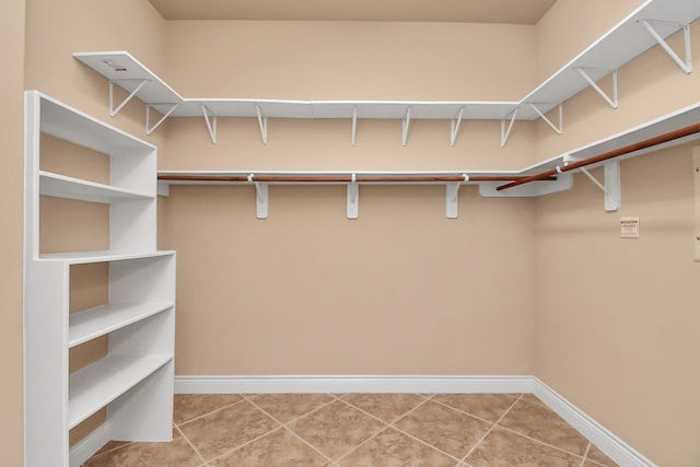 spacious closet featuring tile patterned flooring