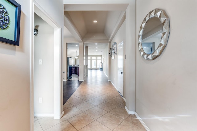 hall featuring light tile patterned flooring