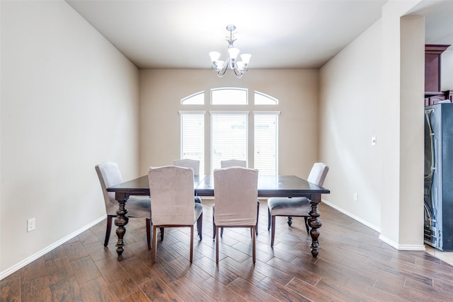 dining area featuring dark hardwood / wood-style floors and an inviting chandelier