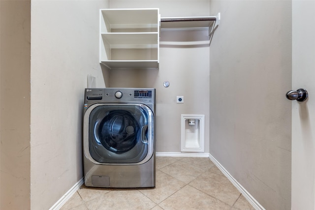 washroom featuring light tile patterned flooring and washer / dryer