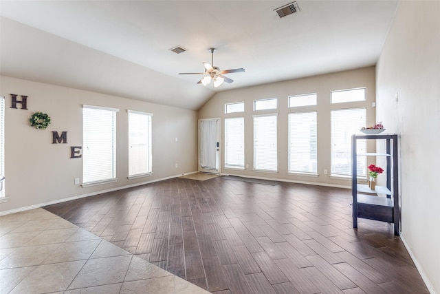 spare room featuring lofted ceiling, wood-type flooring, and ceiling fan