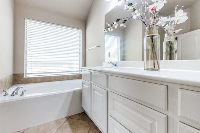 bathroom featuring tile patterned flooring, vanity, and a washtub