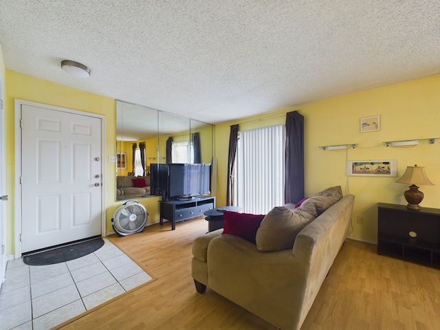 living room featuring light hardwood / wood-style floors and a textured ceiling