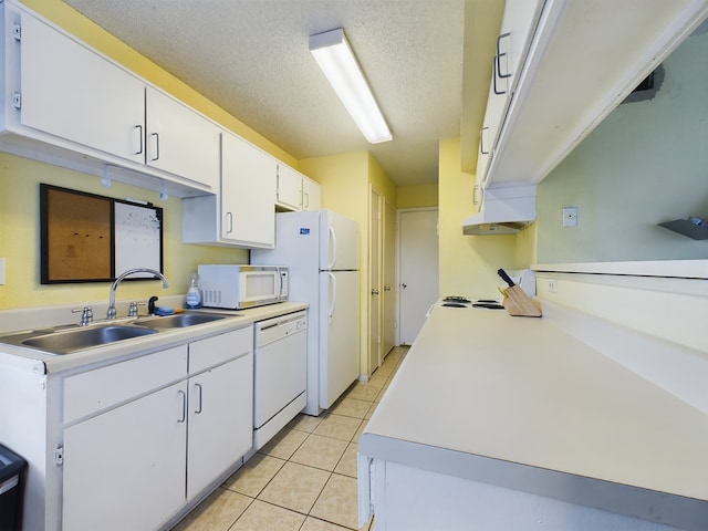 kitchen with sink, white appliances, white cabinetry, a textured ceiling, and light tile patterned flooring