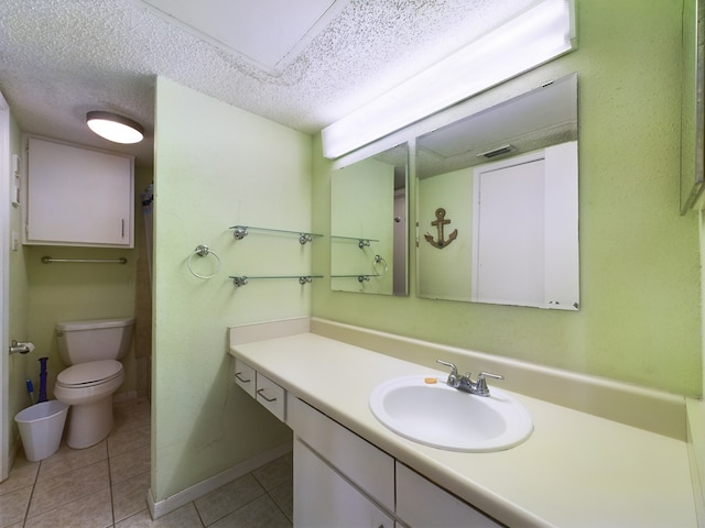 bathroom with vanity, tile patterned floors, a textured ceiling, and toilet