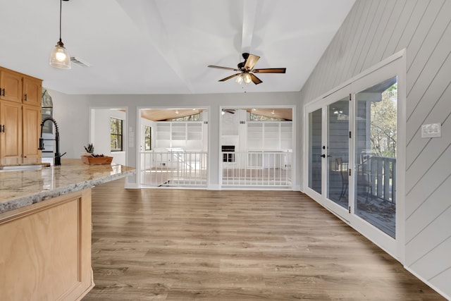 living room featuring lofted ceiling, sink, ceiling fan, and light wood-type flooring