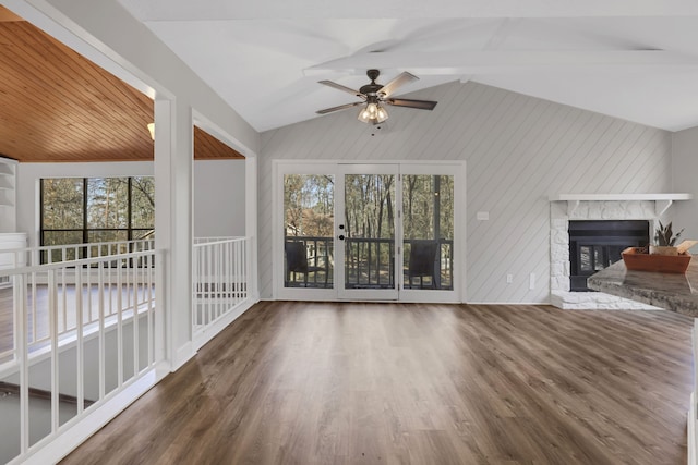 unfurnished living room with ceiling fan, vaulted ceiling with beams, and dark hardwood / wood-style flooring