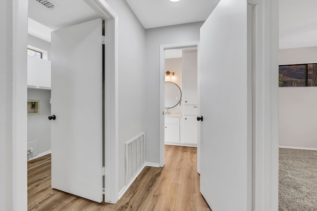 hallway with light wood-type flooring