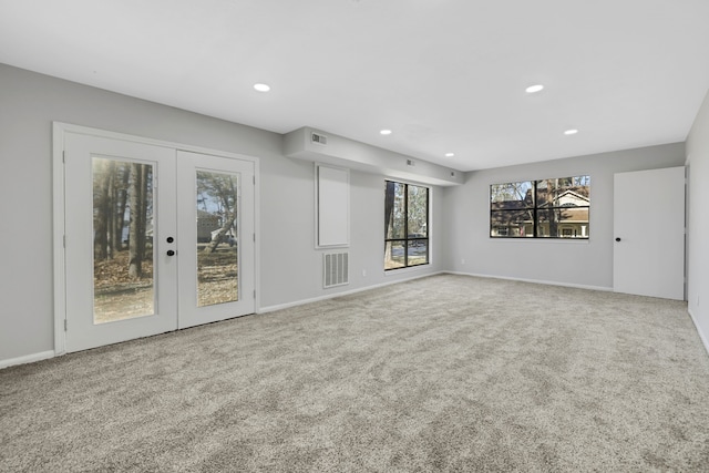 unfurnished living room with french doors and carpet flooring