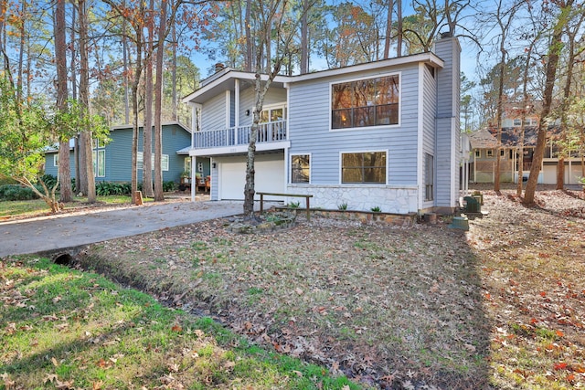 view of front of home with a garage and a balcony