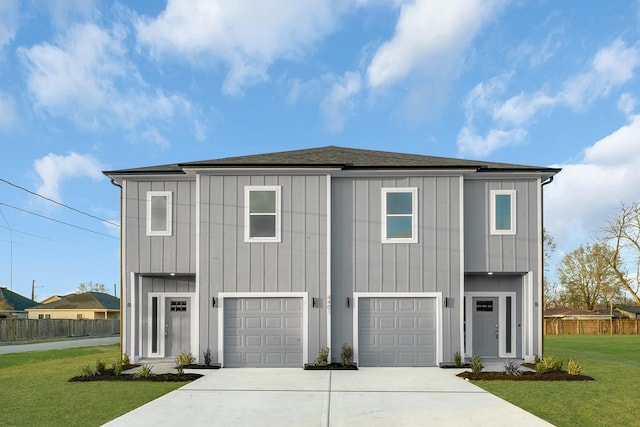 view of front of property with a garage and a front yard