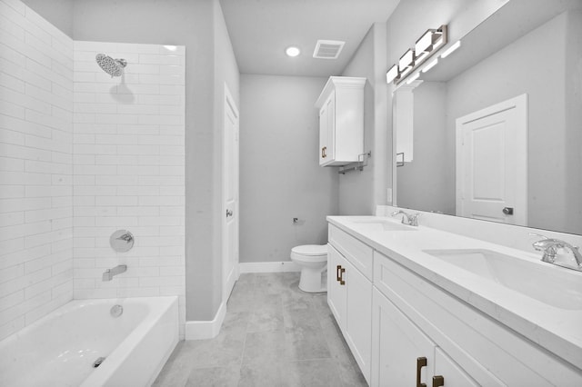 full bathroom featuring tiled shower / bath, vanity, toilet, and tile patterned floors