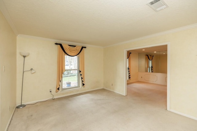 spare room with ornamental molding, a textured ceiling, and carpet