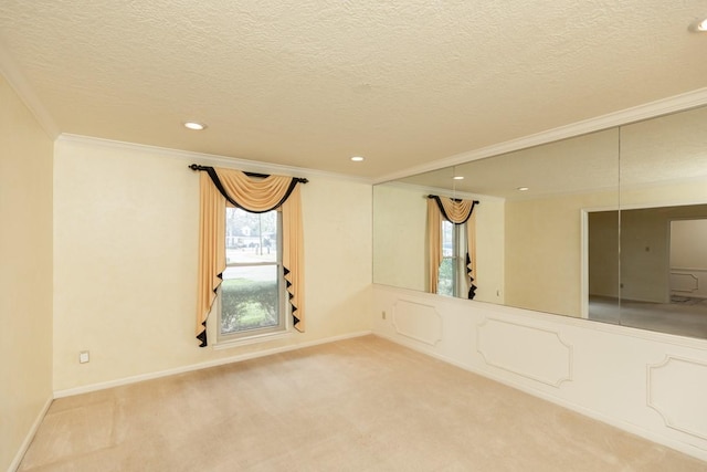 unfurnished room featuring ornamental molding, carpet floors, and a textured ceiling