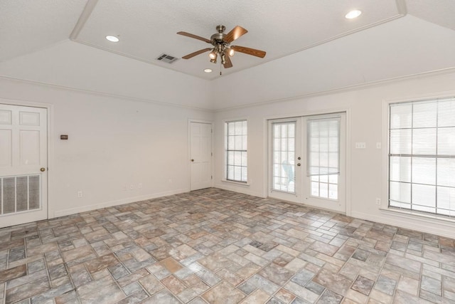 spare room with lofted ceiling, a raised ceiling, ceiling fan, and french doors