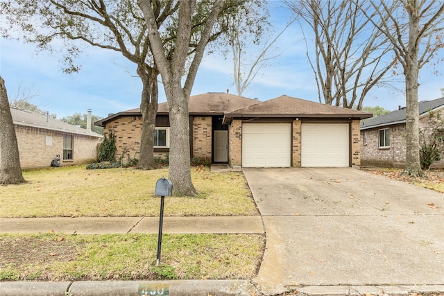 ranch-style house featuring a garage and a front lawn