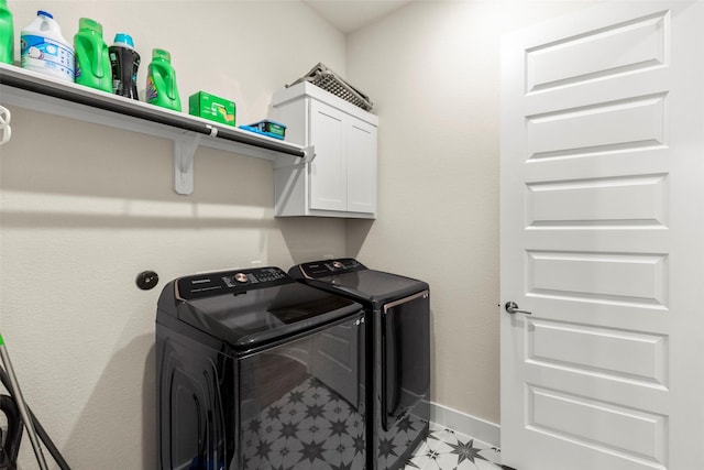 laundry area featuring cabinets and washing machine and clothes dryer