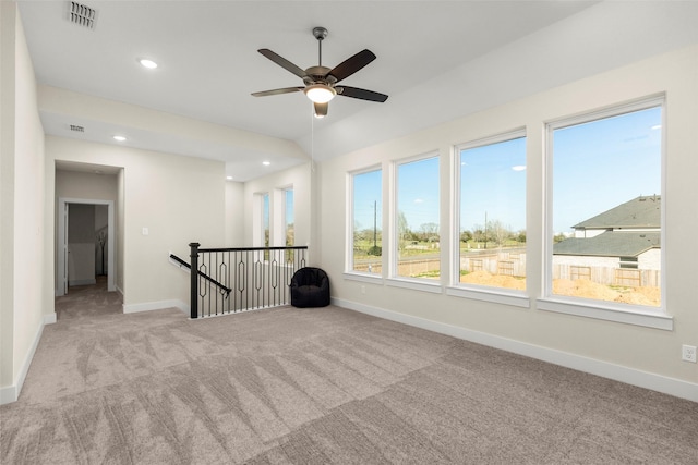 carpeted empty room featuring lofted ceiling and ceiling fan