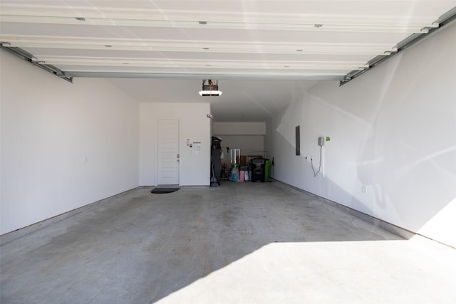 garage featuring a garage door opener and electric panel