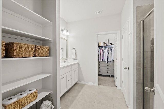 bathroom with vanity, tile patterned flooring, and a shower with door