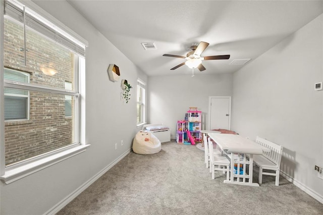 recreation room featuring ceiling fan and light carpet