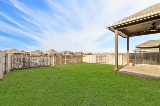 view of yard featuring a patio and ceiling fan