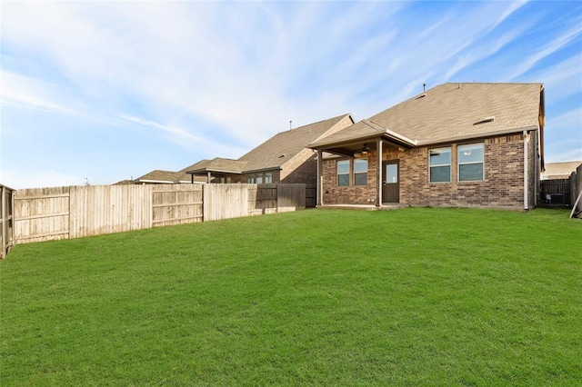 rear view of property with a lawn