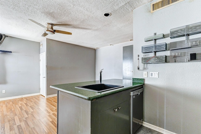 kitchen with sink, a textured ceiling, dishwasher, ceiling fan, and light hardwood / wood-style floors