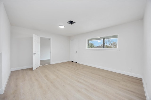 spare room with light hardwood / wood-style floors